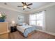 Neutral bedroom featuring a comfortable bed, ceiling fan and lots of natural light from the window at 161 Dorys Way, Dallas, GA 30157