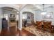 Open-concept dining room with hardwood floors, coffered ceilings, and elegant chandelier with views to the living room at 161 Dorys Way, Dallas, GA 30157