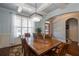 Dining room with a wooden table, a chandelier, hardwood floors, and lots of light from the window at 161 Dorys Way, Dallas, GA 30157