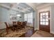 Elegant dining room featuring coffered ceiling, chandelier, hardwood floors, and a wooden door at 161 Dorys Way, Dallas, GA 30157