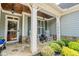 Close-up of a charming front porch with stone accents, rocking chairs, and a decorative front door at 161 Dorys Way, Dallas, GA 30157