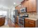 Kitchen showcasing stainless steel appliances and wooden cabinets at 161 Dorys Way, Dallas, GA 30157