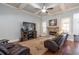 Comfortable living room features coffered ceilings, hardwood floors and a stone fireplace with a mounted TV at 161 Dorys Way, Dallas, GA 30157