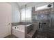 Luxurious main bathroom with separate shower and soaking tub with stone accents at 161 Dorys Way, Dallas, GA 30157