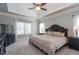 Spacious main bedroom boasts a tray ceiling, neutral color palette, and lots of natural light at 161 Dorys Way, Dallas, GA 30157