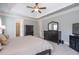 Bright main bedroom with a ceiling fan, dark furniture, and large windows provides relaxation at 161 Dorys Way, Dallas, GA 30157