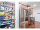 Walk-in pantry featuring ample storage shelves with a view of the stainless-steel refrigerator at 161 Dorys Way, Dallas, GA 30157