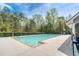 Community pool surrounded by trees and a security fence for residents at 161 Dorys Way, Dallas, GA 30157