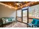 Relaxing screened porch with wood ceiling, outdoor seating, fan and string lights at 161 Dorys Way, Dallas, GA 30157