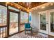 Enjoyable screened porch with wood ceiling, outdoor seating and access to the deck at 161 Dorys Way, Dallas, GA 30157