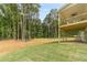 The backyard features a covered deck with a ceiling fan, surrounded by lush greenery and a manicured lawn at 210 Pinewood Dr, Covington, GA 30014