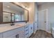 Bathroom featuring a double sink vanity, large mirror, and modern fixtures at 210 Pinewood Dr, Covington, GA 30014