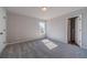 Bedroom with carpeted floors, neutral paint, and a window with a view at 210 Pinewood Dr, Covington, GA 30014