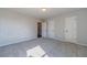 A carpeted bedroom features neutral walls, white doors, and a light fixture at 210 Pinewood Dr, Covington, GA 30014
