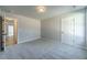 Carpeted bedroom features neutral walls, trim and multiple doors at 210 Pinewood Dr, Covington, GA 30014
