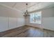 Elegant dining room with natural light, hardwood floors, wainscoting, and modern chandelier at 210 Pinewood Dr, Covington, GA 30014