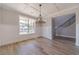 Elegant dining room with hardwood floors, wainscoting, and modern chandelier at 210 Pinewood Dr, Covington, GA 30014