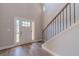 Bright entryway with wood floors, a staircase, and a white door with glass panels at 210 Pinewood Dr, Covington, GA 30014