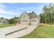 Beautiful two-story home featuring an attached two-car garage surrounded by lush trees at 210 Pinewood Dr, Covington, GA 30014