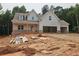 Charming new construction home with a two-car garage and craftsman-style details under construction at 210 Pinewood Dr, Covington, GA 30014