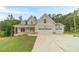 Charming two-story home with a large two-car garage and well-manicured front lawn at 210 Pinewood Dr, Covington, GA 30014