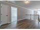 Hallway with wood-style floors, light fixtures, and neutral paint at 210 Pinewood Dr, Covington, GA 30014