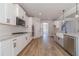 Bright kitchen features white cabinets, stainless steel appliances, and granite countertops at 210 Pinewood Dr, Covington, GA 30014