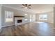 Living room featuring a fireplace, large windows, and backyard access at 210 Pinewood Dr, Covington, GA 30014