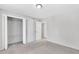 Empty bedroom with light gray carpet, ample closet space, and neutral wall paint at 2390 Lawrenceville Hwy # K, Decatur, GA 30033