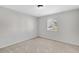 Empty bedroom featuring plush carpeting, neutral walls, and ample natural light from a window at 2390 Lawrenceville Hwy # K, Decatur, GA 30033