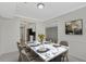Dining room with a marble table set with plates, glasses, and flower centerpiece at 2390 Lawrenceville Hwy # K, Decatur, GA 30033