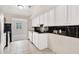 Well-lit kitchen featuring white cabinetry, tile backsplash, and stainless steel appliances at 2390 Lawrenceville Hwy # K, Decatur, GA 30033