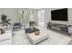 Well-lit living room with a comfortable sofa, modern entertainment center, and serene backyard view at 2390 Lawrenceville Hwy # K, Decatur, GA 30033