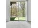 Carpeted room leads to a patio area with sliding glass doors and a leafy green backyard view at 2390 Lawrenceville Hwy # K, Decatur, GA 30033