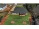 Aerial view of the backyard featuring a covered patio and spacious green lawn at 25 Fourwood Dr, Covington, GA 30016