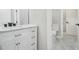Bathroom vanity with white cabinets, marble countertop, and view to commode at 25 Fourwood Dr, Covington, GA 30016