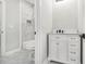 Bathroom with marble floors and shower, white cabinets, and modern fixtures at 25 Fourwood Dr, Covington, GA 30016