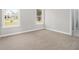 Bright bedroom with neutral carpet, fresh paint, and natural light from two windows at 25 Fourwood Dr, Covington, GA 30016