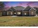 Charming brick home with manicured lawn and a covered front porch at 25 Fourwood Dr, Covington, GA 30016
