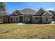 Charming brick home with manicured lawn and a covered front porch at 25 Fourwood Dr, Covington, GA 30016