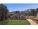 Beautiful brick home with a well-manicured lawn and a long driveway leading up to the entrance at 25 Fourwood Dr, Covington, GA 30016
