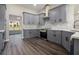 Modern kitchen featuring gray cabinets, granite countertops, and tile backsplash at 25 Fourwood Dr, Covington, GA 30016