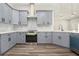 Well-lit kitchen features gray cabinets, modern appliances, mosaic backsplash, and light countertops at 25 Fourwood Dr, Covington, GA 30016