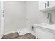 Bright laundry room with white cabinets, new sink and faucet, and light colored walls at 25 Fourwood Dr, Covington, GA 30016