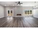 Spacious living room with fireplace, ceiling fan, and natural light at 25 Fourwood Dr, Covington, GA 30016