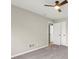 Spacious bedroom with neutral carpet, ceiling fan, and access to the closet and hallway at 5427 Fieldgreen Dr, Stone Mountain, GA 30088