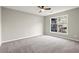 Bedroom featuring carpeted floors, large window, and neutral walls at 5427 Fieldgreen Dr, Stone Mountain, GA 30088