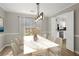 Bright dining room features a modern light fixture, marble dining table, and view to the kitchen at 5427 Fieldgreen Dr, Stone Mountain, GA 30088