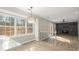 Open concept dining area that leads to a living room with a modern fireplace at 5427 Fieldgreen Dr, Stone Mountain, GA 30088