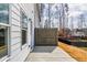 The concrete patio has a wooden fence. The side of the home has a window and a light fixture attached at 125 Priestwood Ln, Acworth, GA 30102
